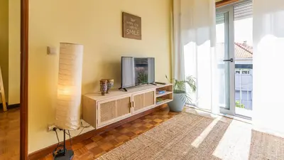 a living room with a couch and a flat screen tv at 5E Apartment in the center of Porto in Porto