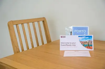 a sign sitting on top of a table next to a chair at GuestReady - Homely experience in Porto in Porto