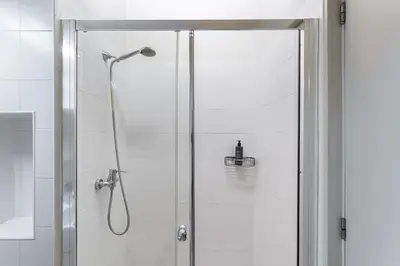 a shower with a glass door in a bathroom at GuestReady - Homely experience in Porto in Porto