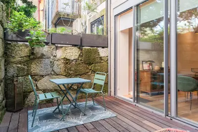 a table and two chairs on a patio at Oliveirinhas Boutique Flats in Porto