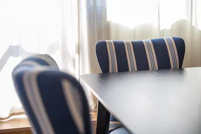 a table and chairs with a table and a window at GuestReady – Urban comfort in Vila Nova de Gaia in Vila Nova de Gaia