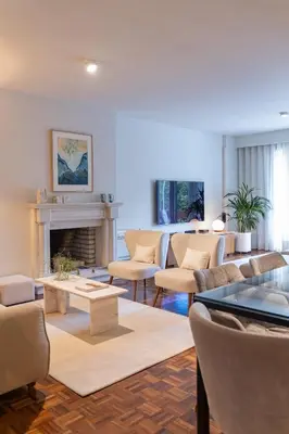 a living room with chairs and a fireplace at Porto Pátio by MP in Porto