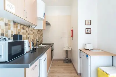 a kitchen with a counter top with a microwave at Cimo Apartments - Center Porto in Porto