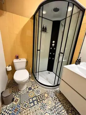 a bathroom with a shower and a toilet and a sink at Downtown Porto Twins II - City Center in Porto