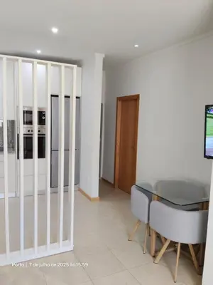 a dining room with a glass table and chairs at Apartment near Porto University Campus T2 in Porto