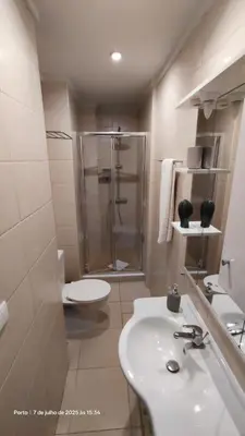 a bathroom with a shower and a sink and a toilet at Apartment near Porto University Campus T2 in Porto