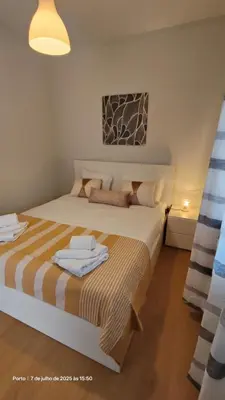 a bedroom with a bed with towels on it at Apartment near Porto University Campus T2 in Porto