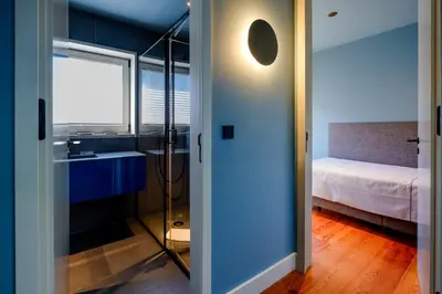 a bathroom with a shower and a bedroom with a bed at Porto Heritage Balcony Apartment in Porto