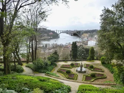 a view of a garden with a bridge in the background at Studios Baixa Downtown Porto in Porto