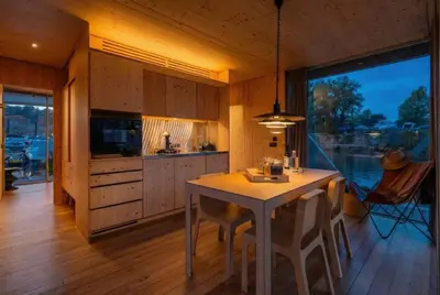 a kitchen with a table and a large window at SLEEPBOAT- Modern Houseboat in Porto in Bicas