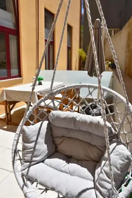 a hanging basket with pillows on a patio at O Refúgio das Caves by Horizon View Madeira in Vila Nova de Gaia