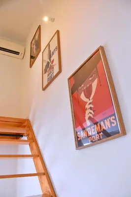 a poster on the wall of a room with a staircase at O Refúgio das Caves by Horizon View Madeira in Vila Nova de Gaia