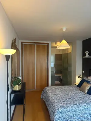 a bedroom with a bed and a lamp at Burnay Porto Suites in Porto