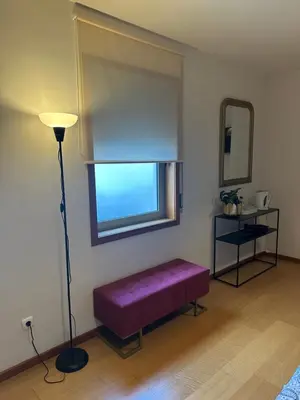 a room with a purple bench in front of a window at Burnay Porto Suites in Porto