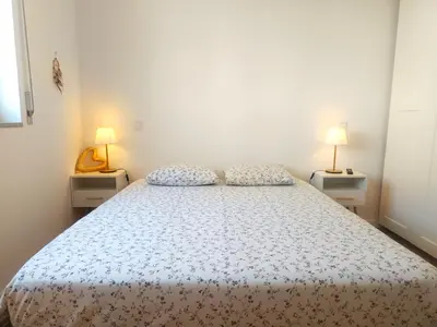 a bedroom with a large bed with two night stands at Charming Campanhã Family Home in Porto