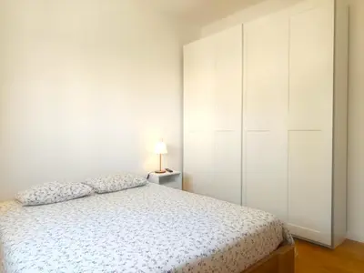a white bedroom with a bed and a white closet at Charming Campanhã Family Home in Porto