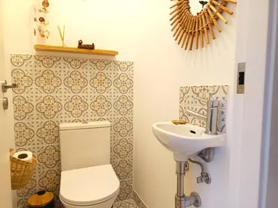 a bathroom with a toilet and a sink at Charming Campanhã Family Home in Porto