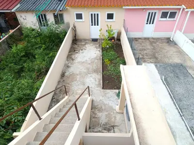 an empty backyard with stairs in front of a house at Charming Campanhã Family Home in Porto