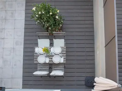 a wooden table with yellow cushions on a patio at Allegro Patio House in Porto