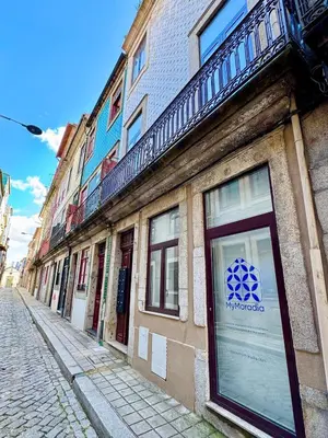 a building with a sign on the side of a street at Historic Porto Flat I Balcony & Views by MyMoradia in Porto