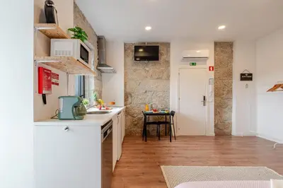 a kitchen with a sink and a counter top at DesKanzo Guest House - Raúl Doria in Porto