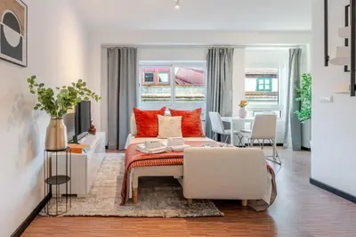 a bedroom with a bed and a living room with a table at Duplex Studio in Art District by HostWise in Porto