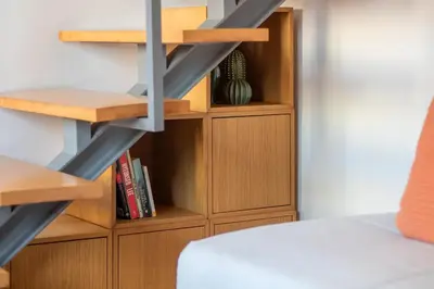 a bedroom with a book shelf and a staircase at Bright 1BR with Parking in Bolhão by LovelyStay in Porto