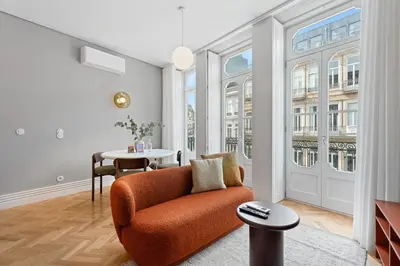 a living room with an orange chair and a table at GuestReady - Music Scale Studios in Porto