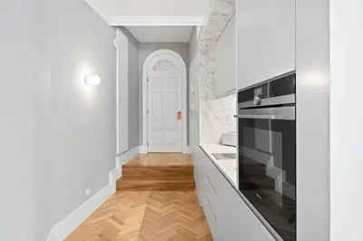 a kitchen with white walls and a white door at GuestReady - Music Scale Studios in Porto