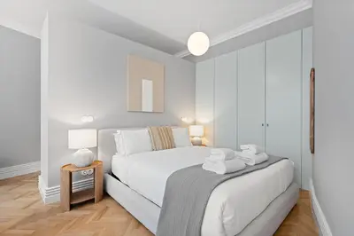 a white bedroom with a bed with towels on it at GuestReady - Music Scale Studios in Porto