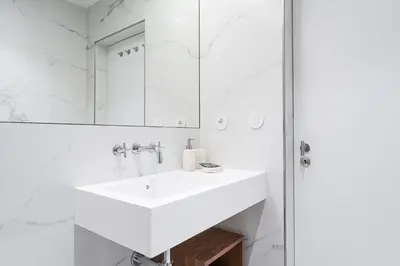 a white bathroom with a sink and a shower at GuestReady - Music Scale Studios in Porto