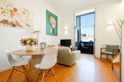 a living room with a table and a couch at Duque Luxury in Porto