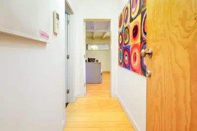 a hallway with a door and a painting on the wall at Duque Luxury in Porto