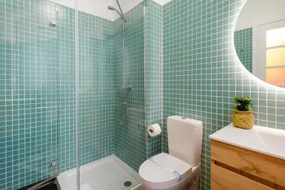 a bathroom with a toilet and a sink and a mirror at Duque Luxury in Porto