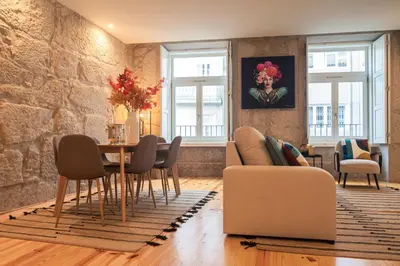 a living room with a table and chairs at Luxury Style 20 with AC Downtown Porto near Metro in Porto