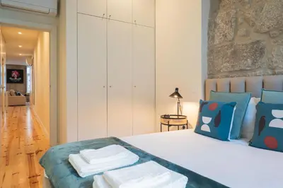 a bedroom with a bed with towels on it at Luxury Style 20 with AC Downtown Porto near Metro in Porto