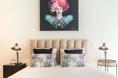 a bedroom with a bed with a painting on the wall at Luxury Style 30 with AC Downtown Porto near Metro in Porto