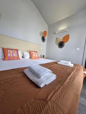 a bedroom with a large bed with towels on it at Blue Orange Porto Apart in Porto