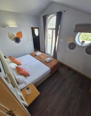 a bedroom with a large bed and a window at Blue Orange Porto Apart in Porto