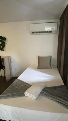 a couple of beds in a room at Gray Red Porto Apart in Porto
