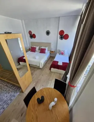 a bedroom with a bed and a mirror and a table at Gray Red Porto Apart in Porto