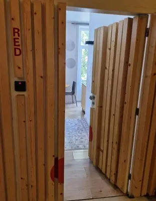 a room with wooden walls and a hallway with a door at Gray Red Porto Apart in Porto