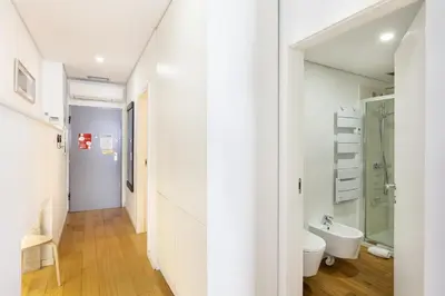 a white bathroom with a toilet and a sink at D&S - Porto Theater Apartment in Porto