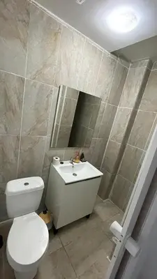 a bathroom with a toilet and a sink at Porto Bonfim suites in Porto
