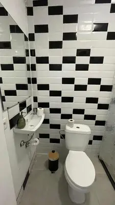 a black and white bathroom with a toilet and a sink at Porto Bonfim suites in Porto