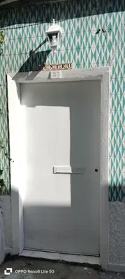a white garage door with a light on top at Porto Bonfim suites in Porto