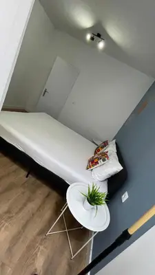 a large bed in a room with a table at Porto Bonfim suites in Porto