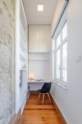 a room with a desk and a chair in front of a window at Cozy Studio with Workspace by HostWise in Porto