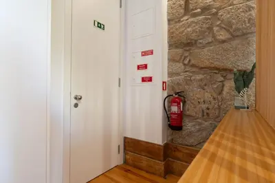 a fire hydrant hanging on a wall next to a door at Cozy Studio with Workspace by HostWise in Porto