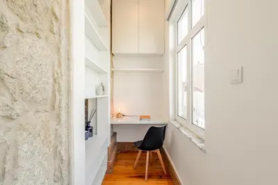 a room with a desk and a chair next to a window at Cozy Studio with Workspace by HostWise in Porto